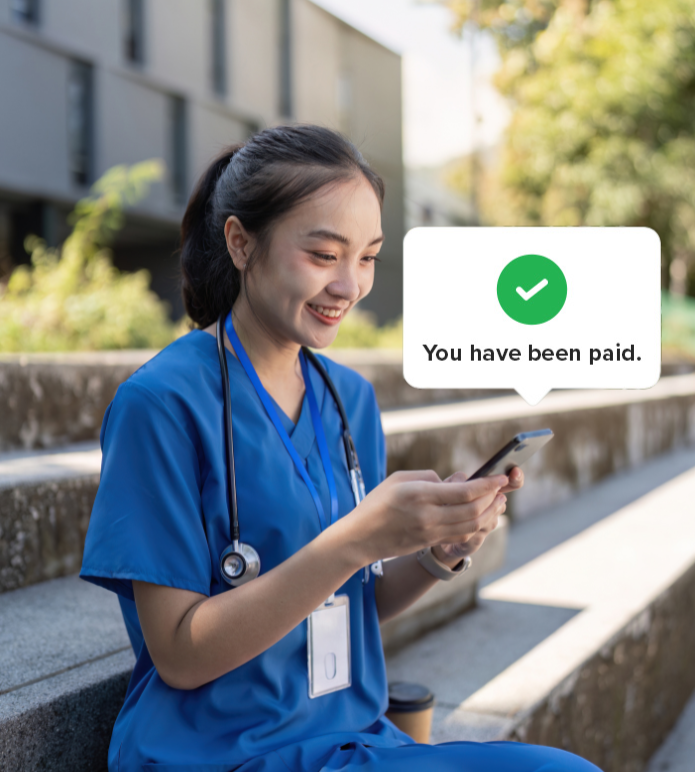 Nurse checks phone and sees payment confirmation message.
