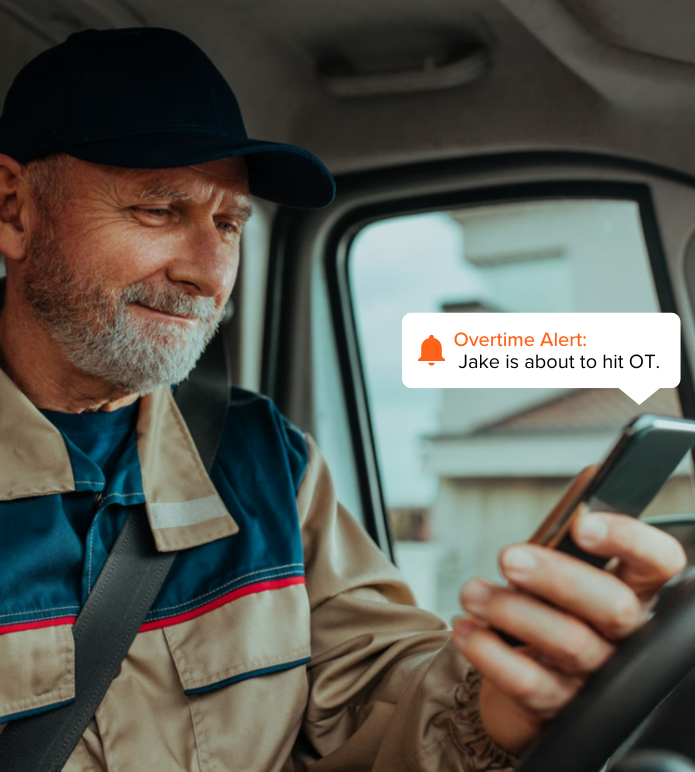 Driver receiving overtime alert on phone, demonstrating automated time tracking for transportation teams.