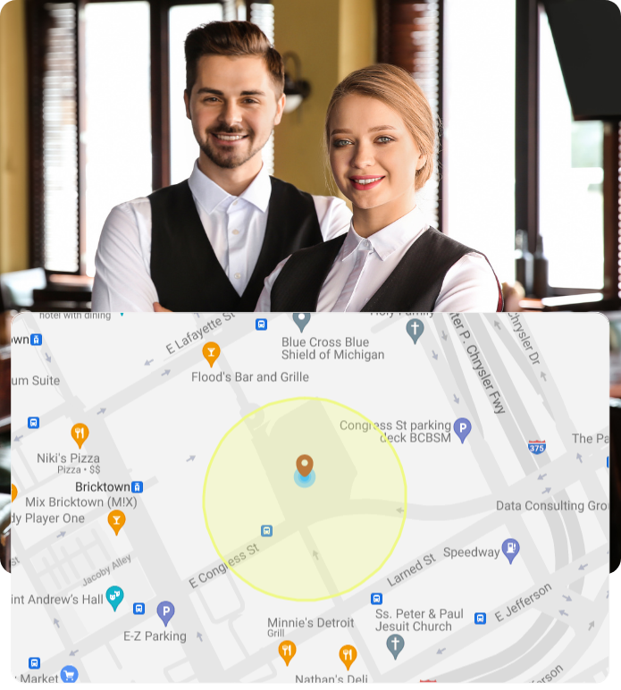  A split-screen image showing two restaurant servers in uniform smiling at the camera in the top half, and a map centered around Congress Street in Detroit, Michigan in the bottom half, possibly indicating a restaurant location or service area.