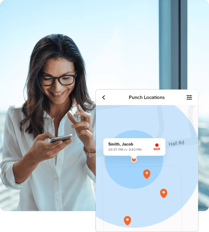 A smiling operations manager uses a smartphone app to track employee 