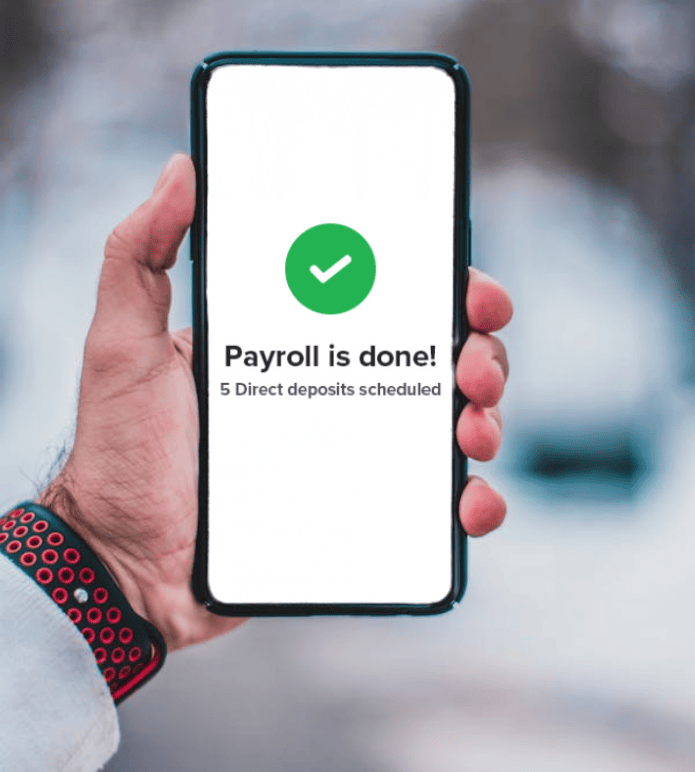 Hand holding phone showing payroll confirmation message