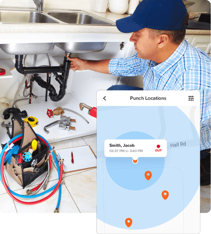 A plumber is working under a kitchen sink with various tools and parts nearby. An overlay on the image shows a digital punch location