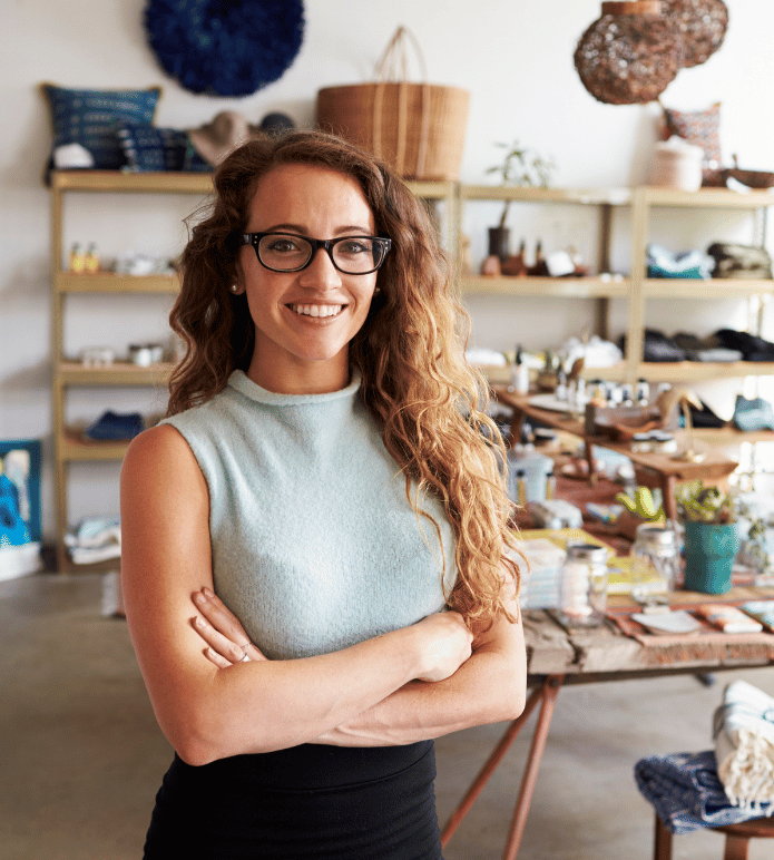Confident small business owner standing in her store